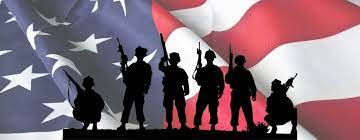 Military members silhouetted in front of an American flag Military members silhouetted in front of an American flag